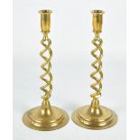 A pair of brass twist stem candlesticks on spreading circular bases, height 30.5cm.