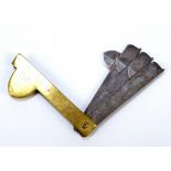 A brass Borwick cast steel fleam, with three graduated blades, length 9cm when folded.