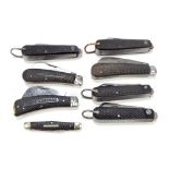 A collection of eight checkered black bodies pocket knives,