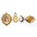 A group of four late 19th/early 20th century unmarked yellow or gilt metal pendants and brooches