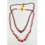 A cherry amber coloured graduated bead necklace, overall length 110cm, the largest bead approx 2.