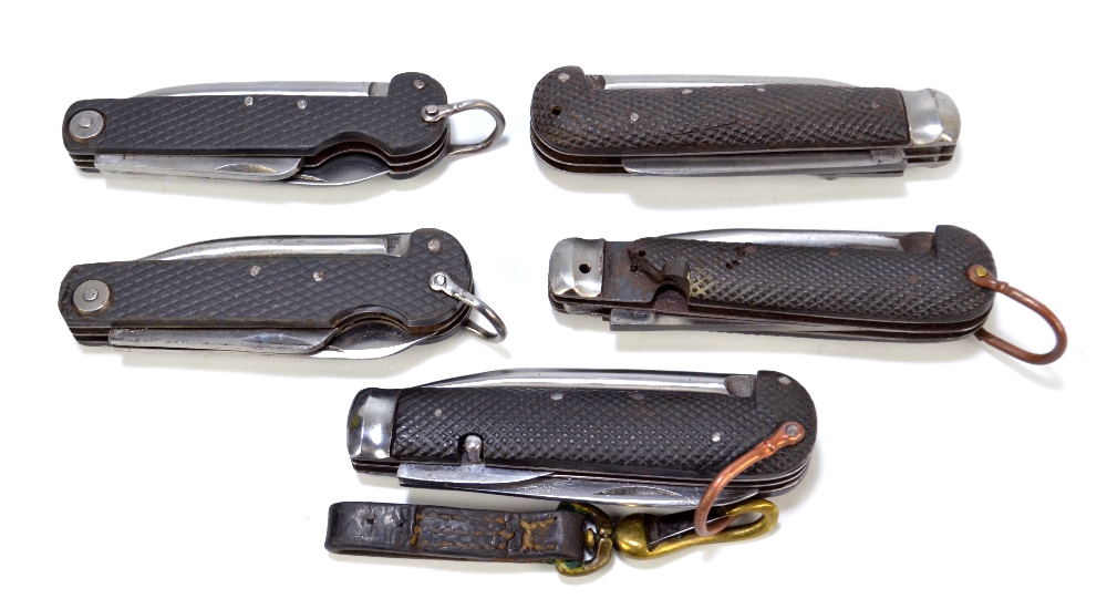 Five military clasp knives with moulded checkered pattern bodies with single blade,