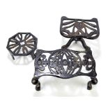 Three various painted wrought iron trivets including an adjustable tripod example,