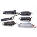 Five military clasp knives with moulded checkered pattern bodies with single blade,