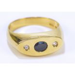 An 18ct yellow gold gentleman's signet ring set with oval cut sapphire and flanked by two round cut