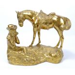 A cast brass figure group of a cowboy playing the harmonica, seated next to his horse, height 29cm.