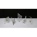 A collection of boxed Swarovski crystal musical instruments to include harp, grand piano and stool,