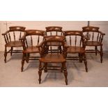 A set of five elm seated smokers' bow-back elbow chairs, labeled for 'Kirk and Townsend,