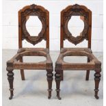 A walnut Arts and Crafts carved hall chair with heavily-carved block supports and backrails with