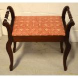 A mahogany piano stool with hinged seat.