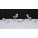 A collection of boxed Swarovski crystal zoo animals to include lion on plinth, giraffe, elephant,