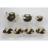 A Doulton Aesthetic Movement eleven-piece tea service, the teapot,