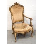 A Victorian gentlemen's salon chair with scrolling arms raised on carved cabriole supports with