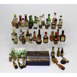 A small quantity of miniature alcohol bottles to include Dimple etc and two boxed vintage candles