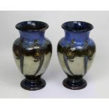 A pair of Royal Doulton Secessionist baluster vases with Art Nouveau floral decoration,