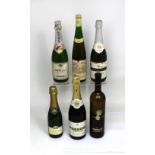 A bottle of 1973 Pomagne Champagne cider, two bottles of Asti Spumante,