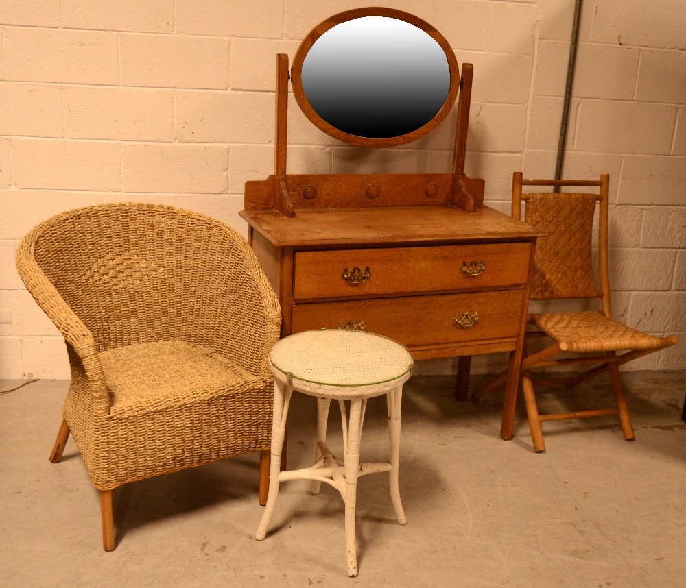 An Edwardian oak oval mirror-back dressing table, two drawers over one long drawer,