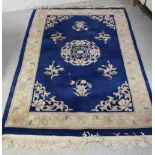 A blue ground wool Oriental rug decorated with flora and abstract design in Oriental pattern,