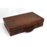A vintage leather suitcase with brass locks.