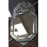 A Venetian-style octagonal wall mirror with leaf and floral decoration, length 90cm.