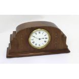 A French mantel clock in Art Deco style walnut case, the white enamel dial set with Roman numerals,