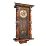 A late 19th/early 20th century mahogany-cased Vienna-style wall clock with glazed pendulum display