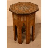 An early 20th century oak octagonal sewing table in the Indian style,