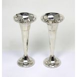 A pair of George V hallmarked silver trumpet vases of tapered form on spilling circular loaded