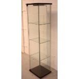 A modern single-door glazed display cabinet with three glass shelves and electric light fitting,