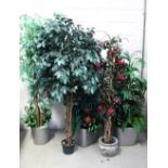 Five ornamental faux decorative plants in ceramic and painted containers,
