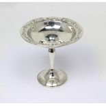 A sterling silver tazza, the rim with repoussé scroll motif,