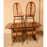 An Ercol extending dining table and four chairs (5).