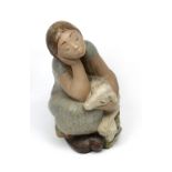 Lladró; a large limited edition figure of young girl with lamb sitting on a rocky plinth,