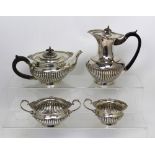 A George VI hallmarked silver tea service comprising a tea pot, milk jug, sugar bowl, Walker & Hall,