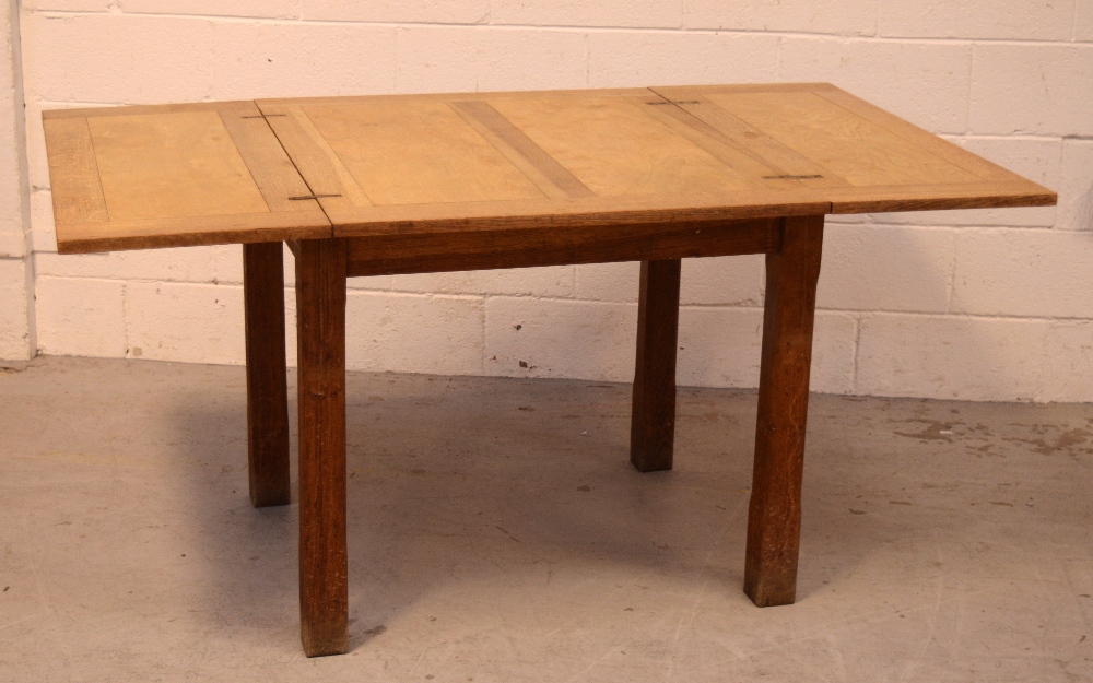 An early 20th century oak twist-out dining table on block supports, length when extended 174cm.