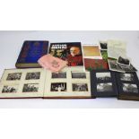 Two photograph albums containing mainly Edwardian topographical and figural postcards,