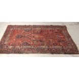 A late 19th/early 20th century Persian red ground rug, approx 190x 150cm.