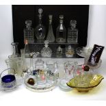 A quantity of moulded glass to include decanters, perfume bottles, pepper pots etc.
