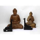 Two carved Siamese figures in prayerful pose,