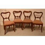 A set of four Victorian mahogany balloon-back dining chairs on cabriole legs (4).