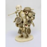 A 19th century Japanese Tokyo school ivory figurine, 'The Basket Seller',