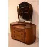 A c1950s oak mirror-back dressing table with a large bevelled shaped mirror, height 160cm,