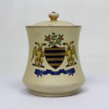 A MacIntyre crested tobacco jar, cream ground with armorial decoration to front,