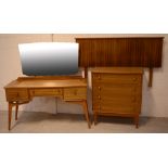 A mid-20th century three-piece teak bedroom suite comprising a chest of four long drawers,