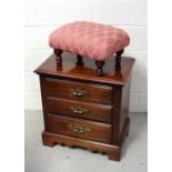 A reproduction three-drawer cabinet with reeded side to shaped plinth base,