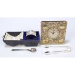 A cased hallmarked silver napkin ring, a pair of hallmarked silver sugar tongs,