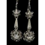 A pair of 18ct white gold drop earrings, each set with two diamonds, the larger approx 0.