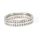 An 18ct white gold eternity ring set with two rows of numerous melee diamonds, size N, approx 4.1g.