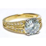 An 18ct yellow gold moissanite and diamond set ring,