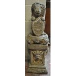 A composite garden statue modelled as a stylised lion clutching a crested shield with motto 'Absque